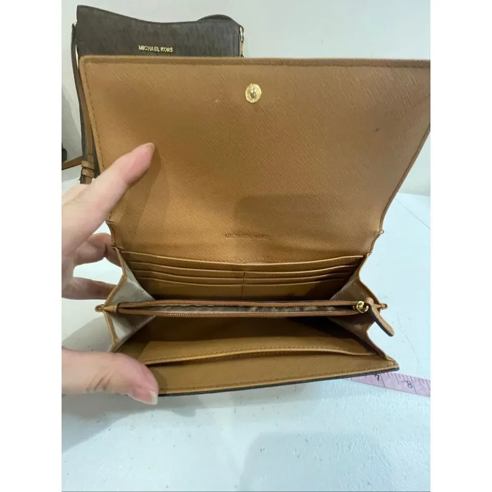 a Michael Kors Jet Set Travel Large Messenger Bag, featuring the brand's signatu